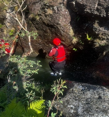 Person jumping into a canyon