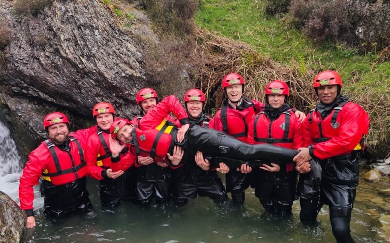Group of men holding the groom up during a stag adventure