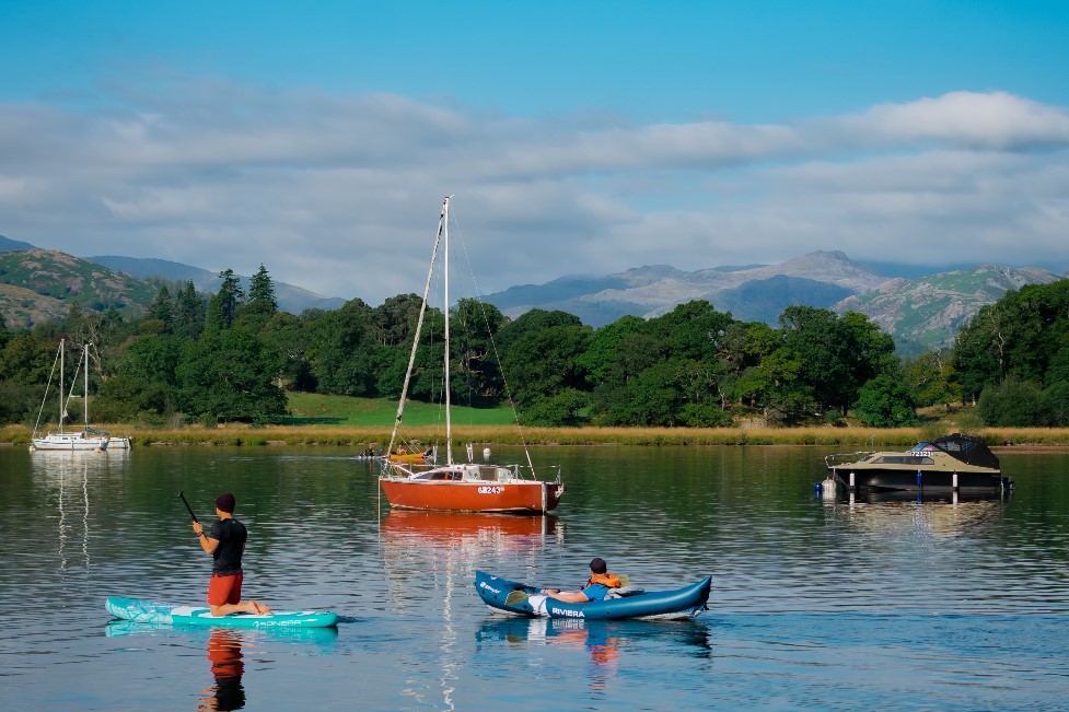 A kayaker and paddleboater on Windermere in the Lake District