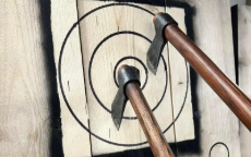 Two axes wedged in a wooden target after having been thrown