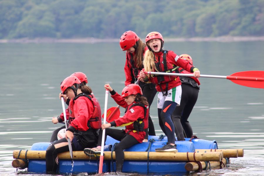 Group of girls paddling a raft on Derwentwater