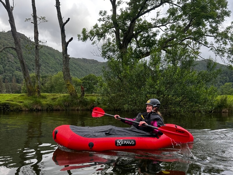 Woman packrafting on a river