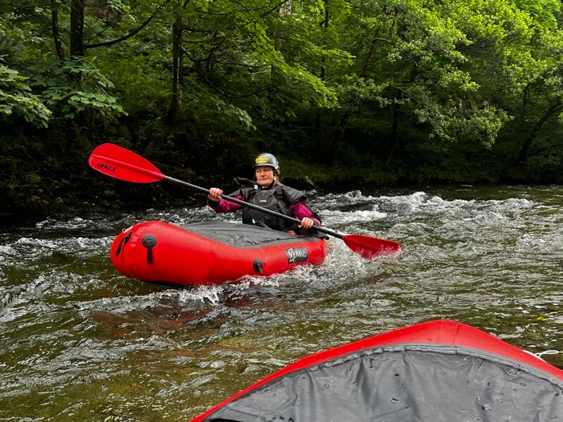 Packrafting on gentle river rapids