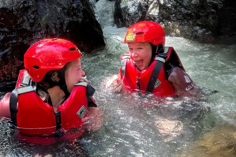 Two girls laughing in the ghyll