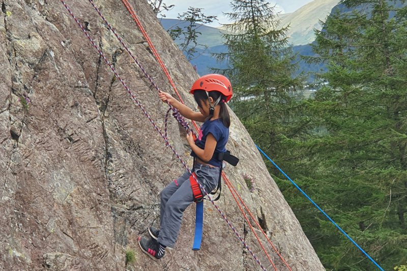 Young girl rock climbing in the Lake District
