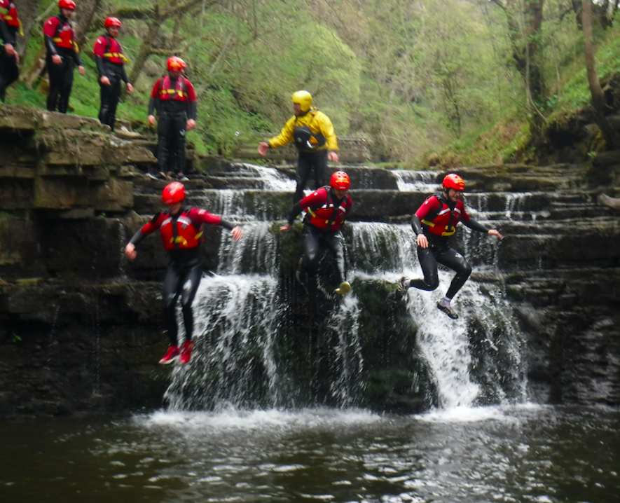Stag group jumping off a waterfall in the Lake District