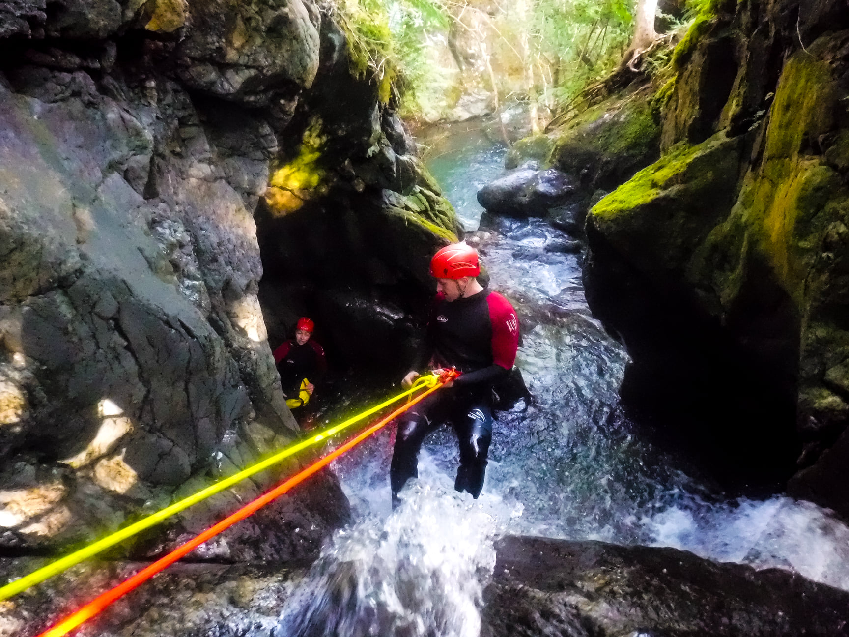 Abseiling down a waterfall during canyoning