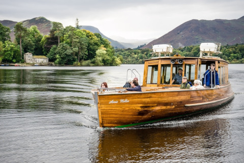 The Keswick Launch boat on Derwentwater, with mountains and Derwent Isle in the background