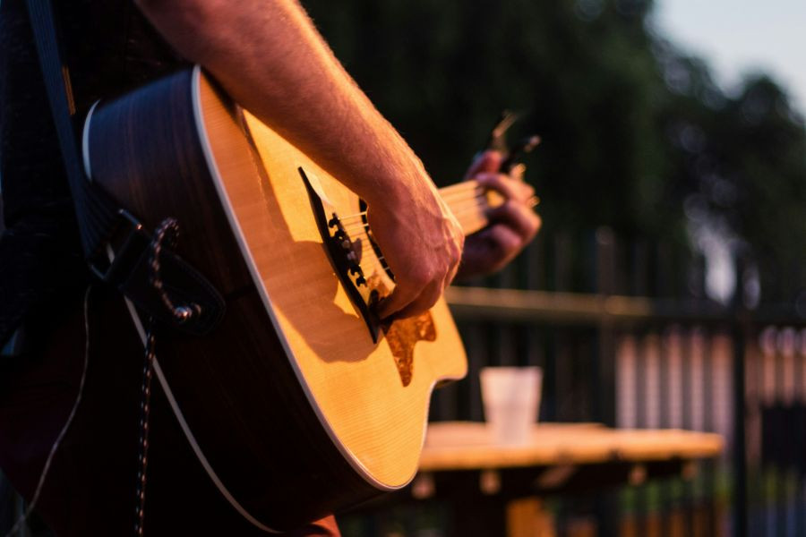 Person playing a guitar in a bar