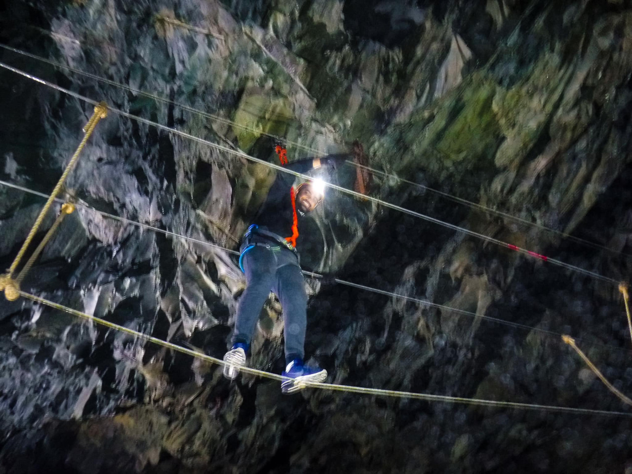 A man on a wire bridge at Climb the Mine in Honister